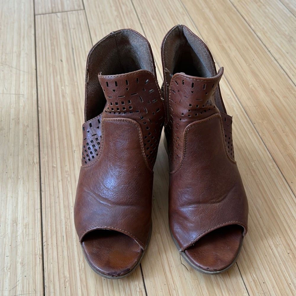 Very worn, tan ankle boots.  Very comfortable